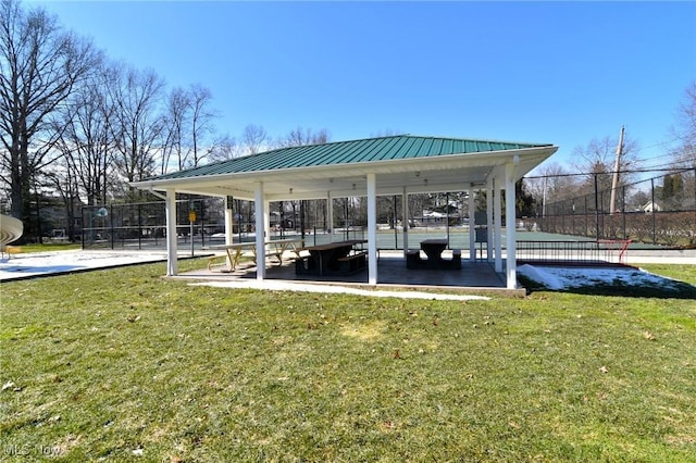 view of home's community featuring fence and a lawn