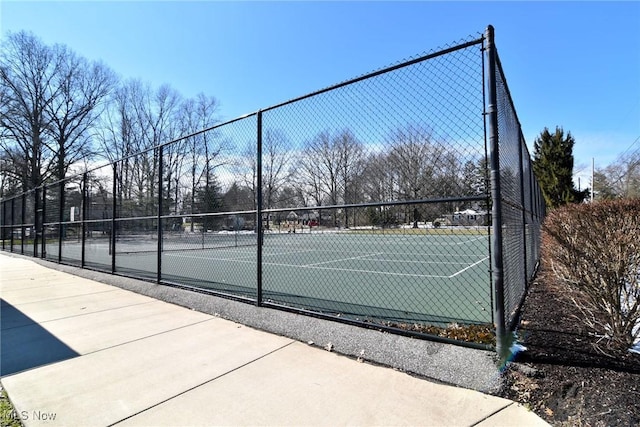 view of tennis court with fence