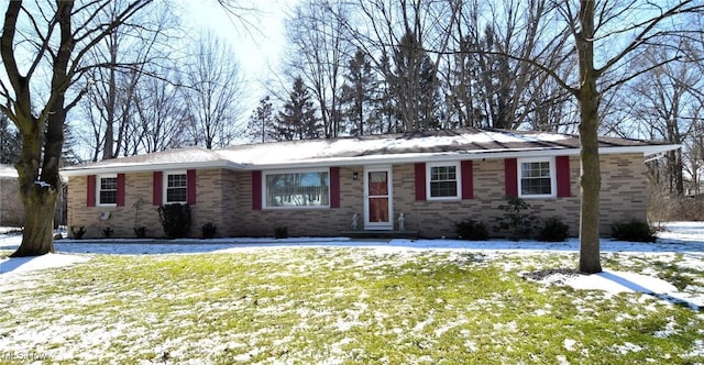 single story home with a yard and brick siding