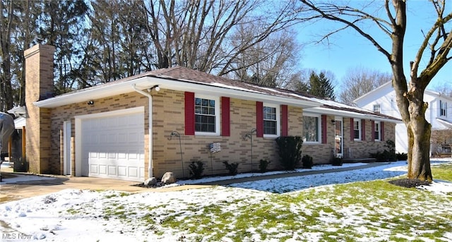 view of front facade with concrete driveway, brick siding, a chimney, and an attached garage