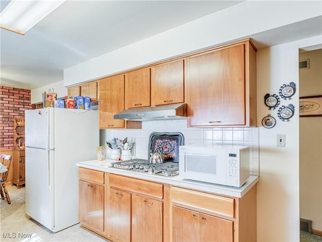 kitchen featuring light countertops, white appliances, backsplash, and under cabinet range hood