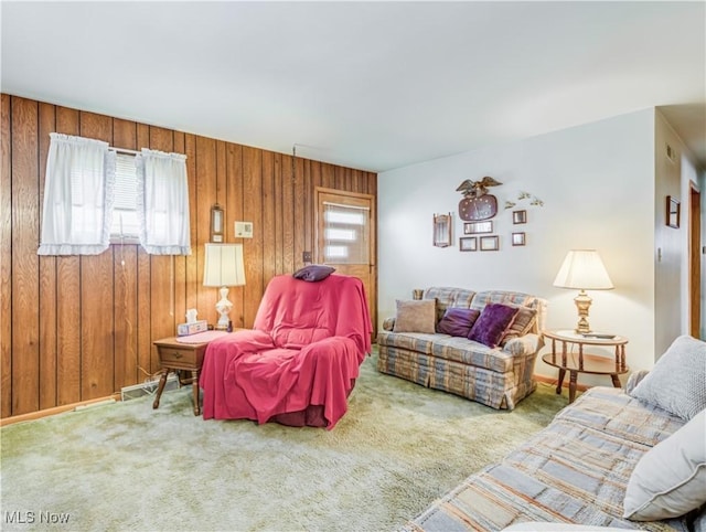 living room with carpet floors and wood walls