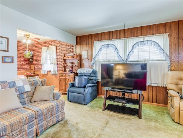 living area with carpet floors, plenty of natural light, and wooden walls