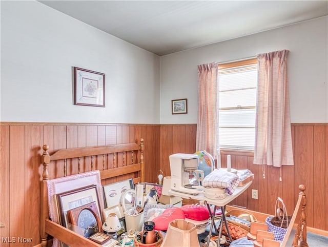 dining room with a wainscoted wall and wood walls