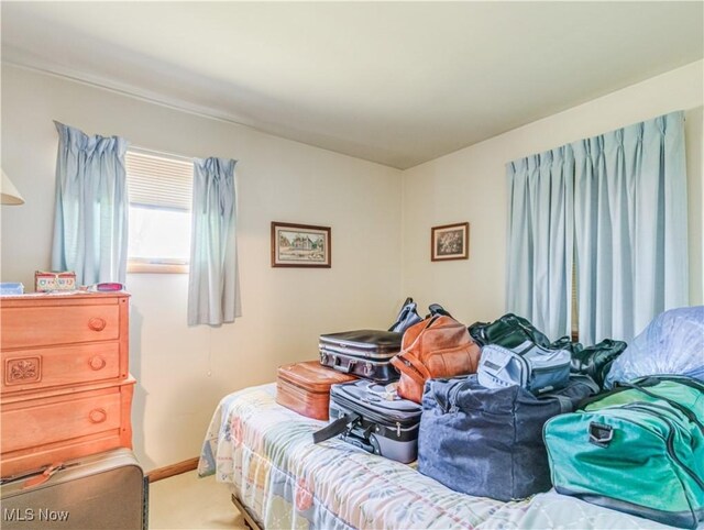 carpeted bedroom featuring baseboards