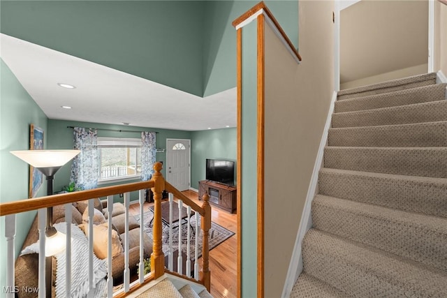 stairs featuring recessed lighting, wood finished floors, and baseboards