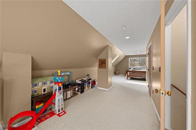 rec room with carpet, lofted ceiling, and baseboards