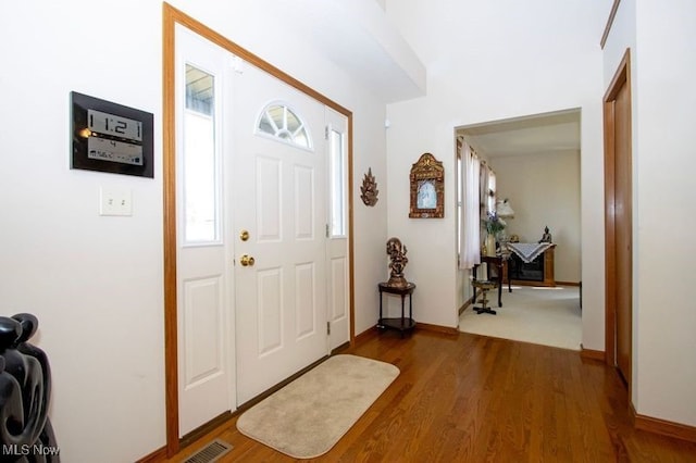 foyer entrance featuring wood finished floors and baseboards