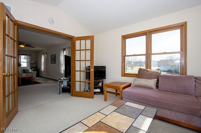 carpeted living room with lofted ceiling and french doors