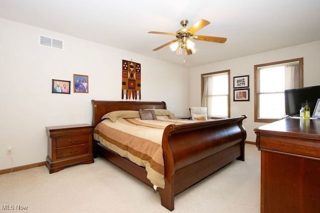 bedroom featuring light carpet, visible vents, and baseboards