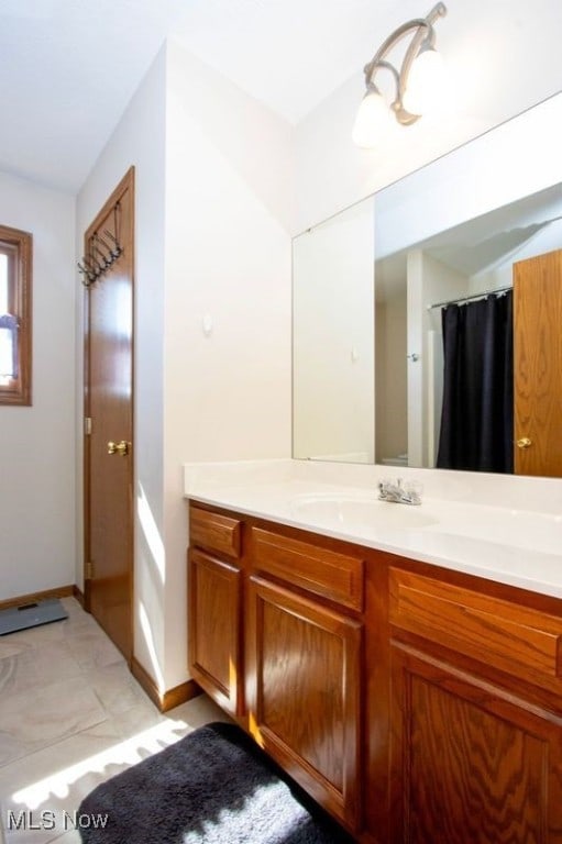 bathroom with vanity and baseboards