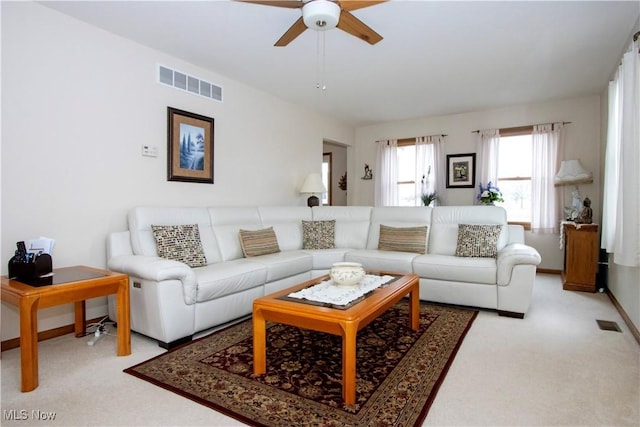 living area with carpet, visible vents, and baseboards