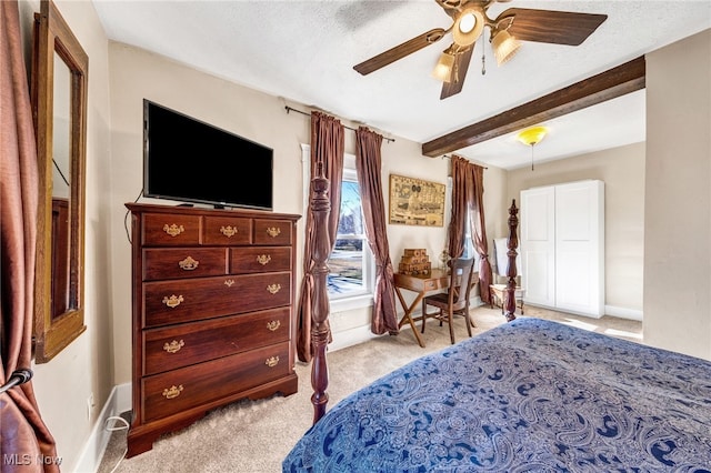 bedroom with beam ceiling, light carpet, ceiling fan, a textured ceiling, and baseboards