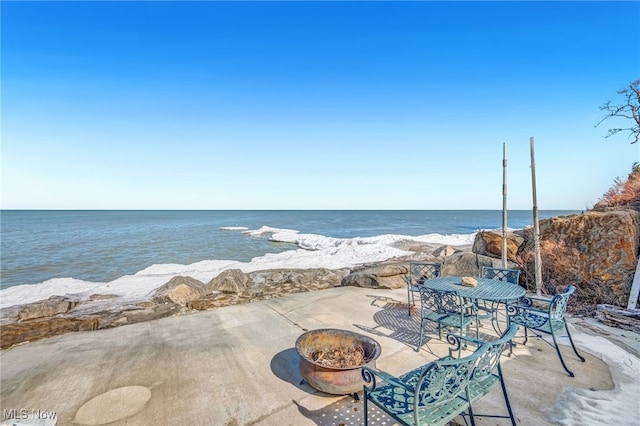 view of patio / terrace featuring a fire pit and a water view