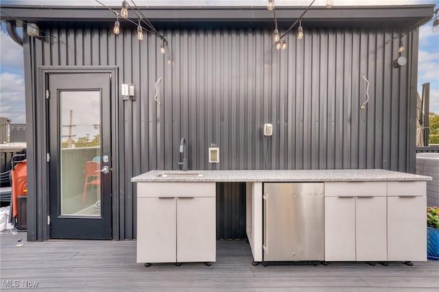 wooden deck featuring a sink