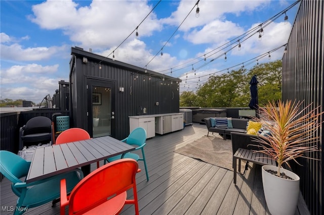 deck featuring outdoor dining area and outdoor lounge area