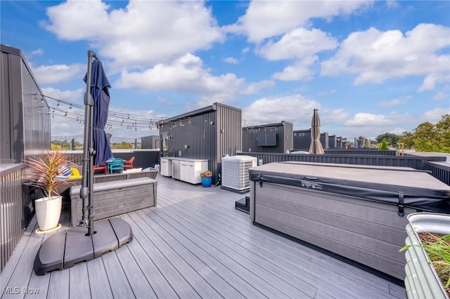 deck with central AC and a hot tub