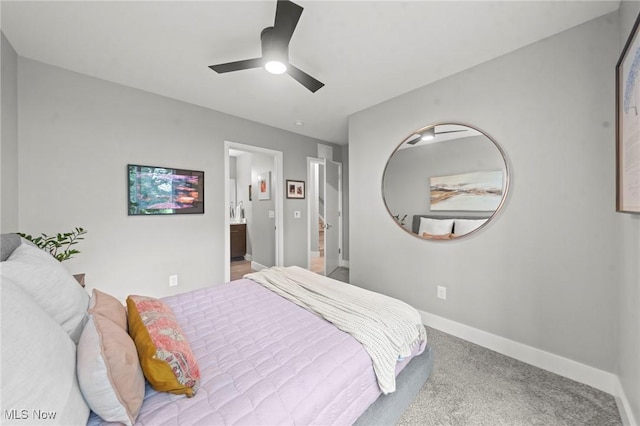 carpeted bedroom with connected bathroom, a ceiling fan, and baseboards