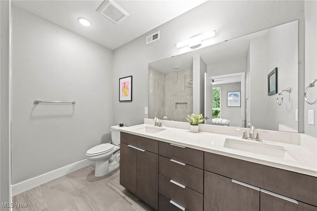 bathroom with toilet, visible vents, a sink, and tiled shower