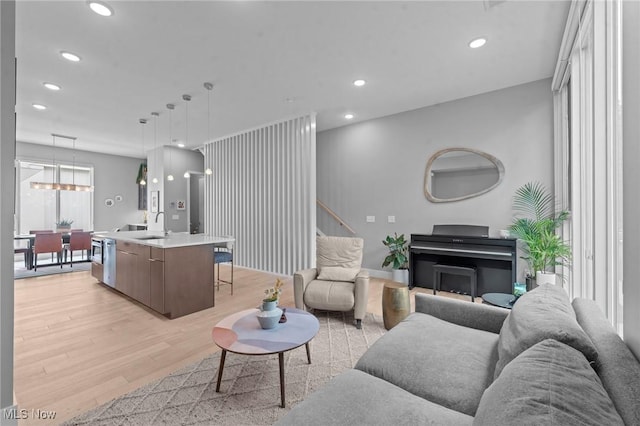 living area with light wood-type flooring and recessed lighting