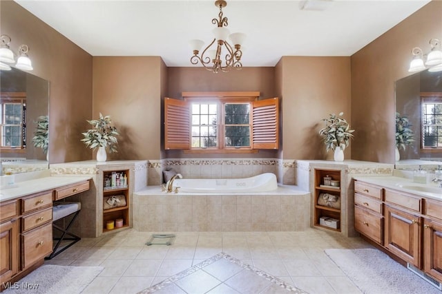 bathroom with plenty of natural light, a garden tub, vanity, and tile patterned floors