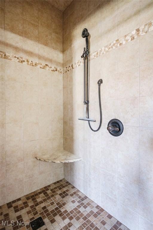 bathroom with tiled shower