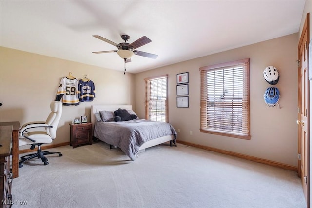 bedroom featuring light carpet, ceiling fan, and baseboards