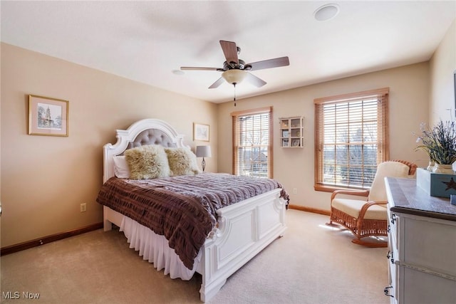 bedroom featuring baseboards, a ceiling fan, and light colored carpet