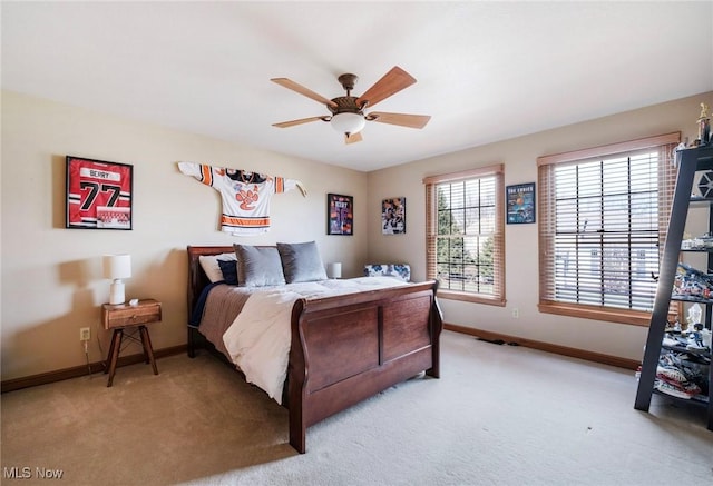 bedroom with light carpet, ceiling fan, and baseboards