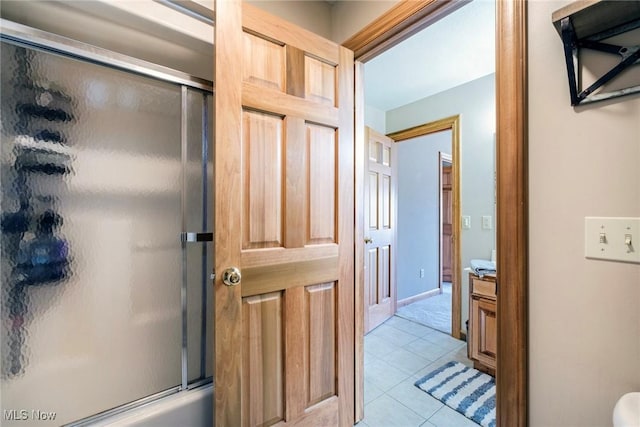 full bath featuring tile patterned flooring, vanity, and a shower with shower door