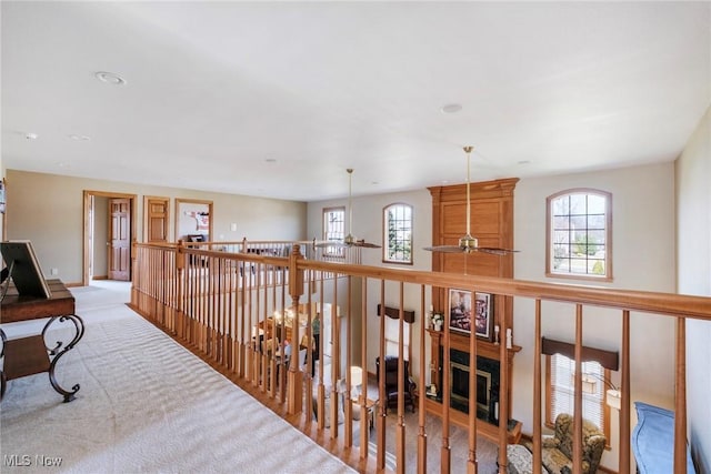 hall featuring carpet and baseboards