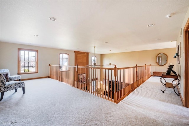 hall with carpet, baseboards, and recessed lighting