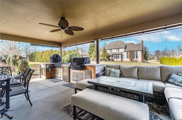 view of patio / terrace featuring an outdoor kitchen, outdoor dining space, a grill, ceiling fan, and an outdoor living space