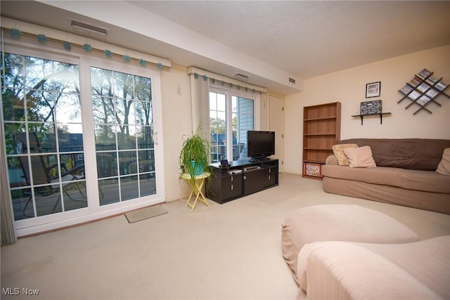 carpeted living area featuring visible vents