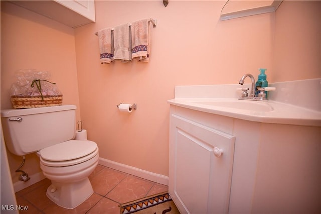 half bath with toilet, tile patterned flooring, baseboards, and vanity