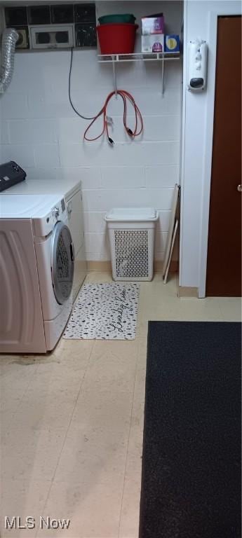 clothes washing area with washer and dryer