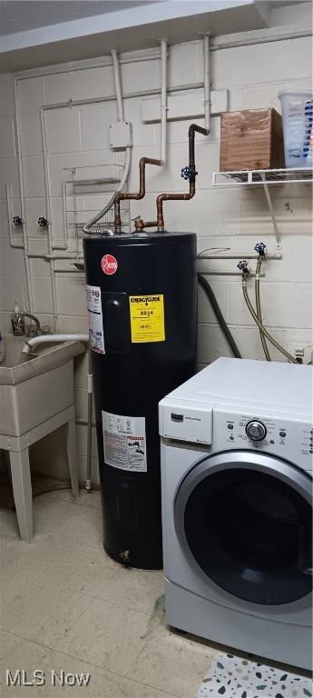 laundry area with laundry area, washer / clothes dryer, and electric water heater