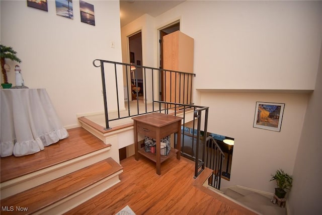 stairway featuring wood finished floors