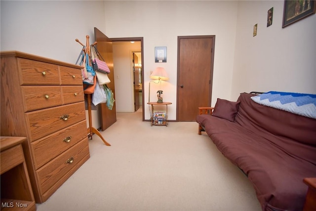 living area featuring light carpet