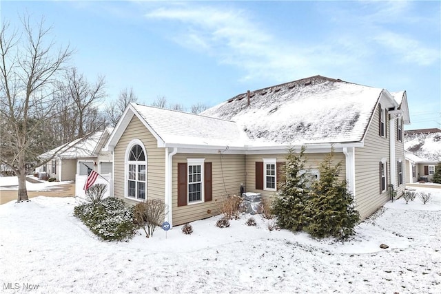 single story home with a garage and roof with shingles