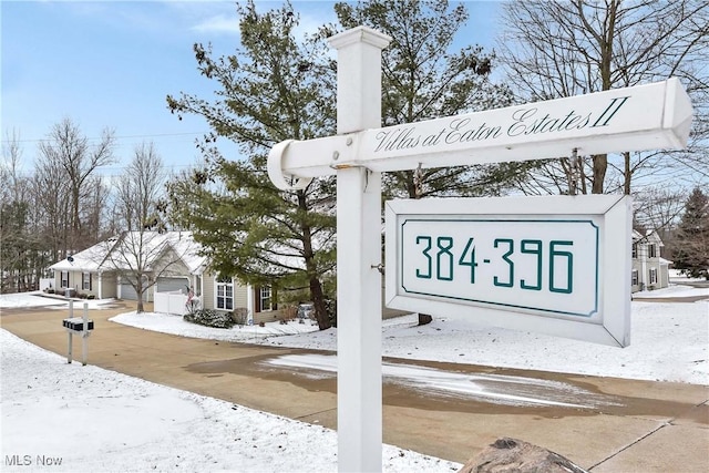 community sign featuring a garage