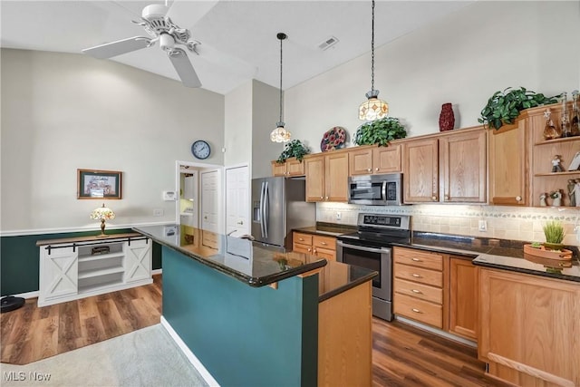 kitchen with dark countertops, open shelves, visible vents, and stainless steel appliances