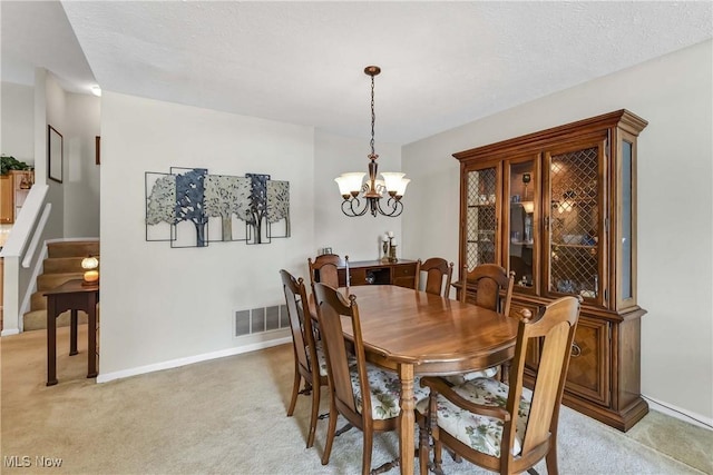 dining area with stairway, light carpet, a notable chandelier, and visible vents