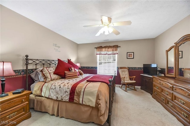 bedroom featuring light colored carpet and ceiling fan