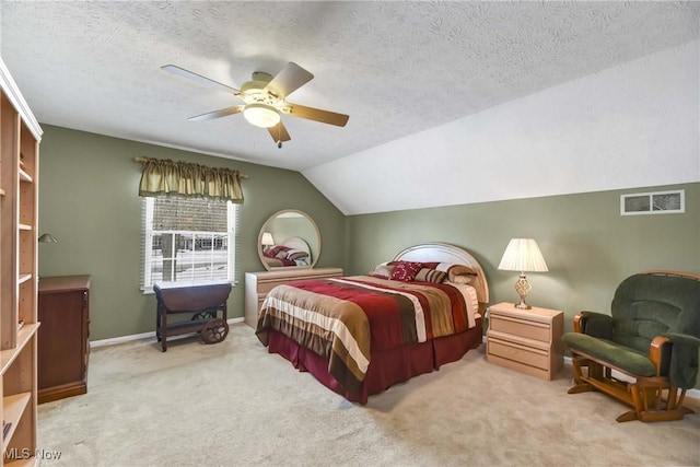 bedroom featuring carpet floors, lofted ceiling, visible vents, and a textured ceiling