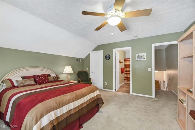 bedroom featuring visible vents, light carpet, vaulted ceiling, a textured ceiling, and baseboards