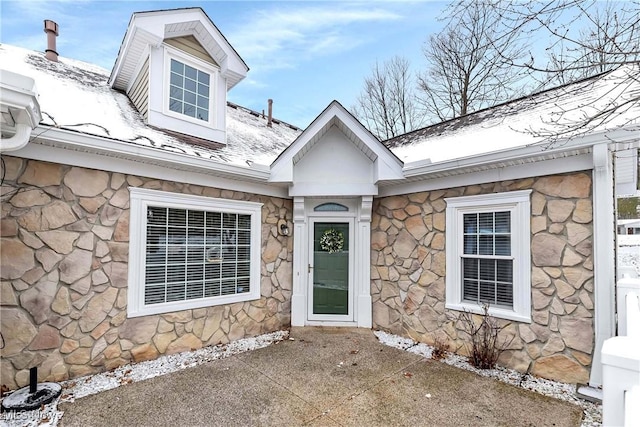 view of exterior entry featuring stone siding