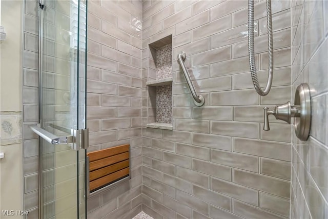 full bath with a tile shower