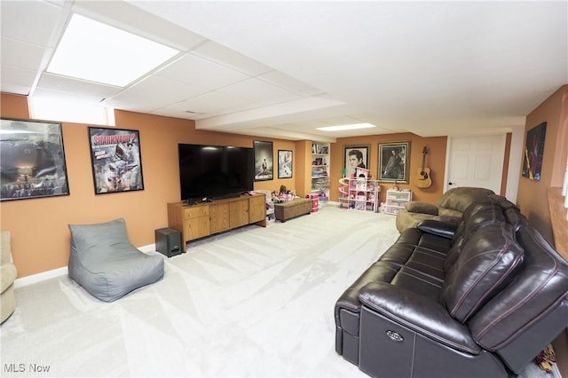 carpeted living area featuring baseboards