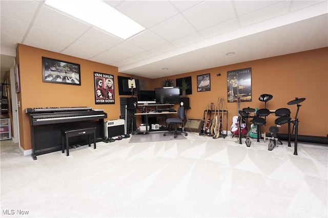 miscellaneous room featuring carpet flooring and a paneled ceiling